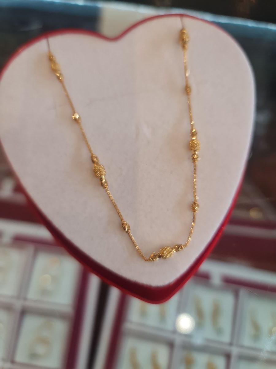 A fine 22ct gold station necklace with patterned gold beads, Kowaj Jewellers